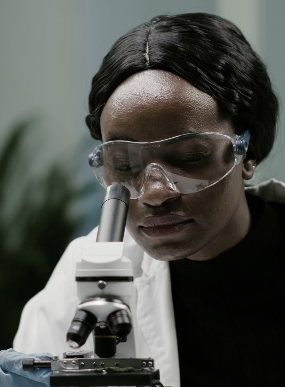 Researcher using a microscope